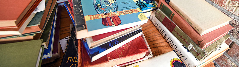 stacks of books on a table at Bolivar County Library System